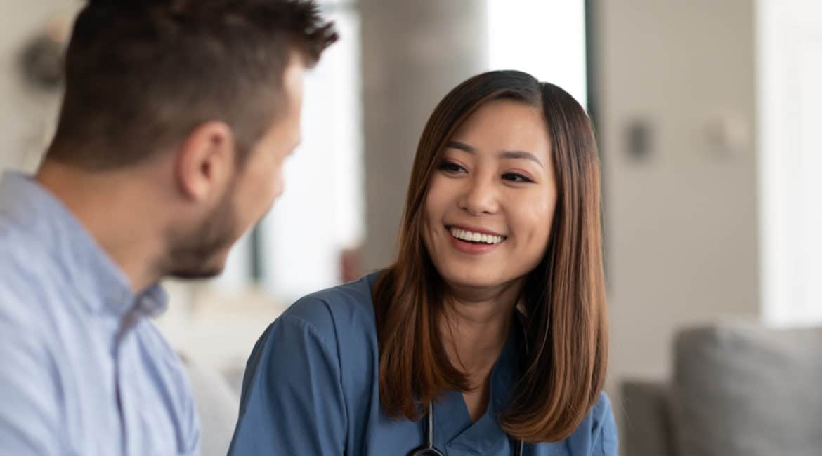 Female doctor smiling at male client