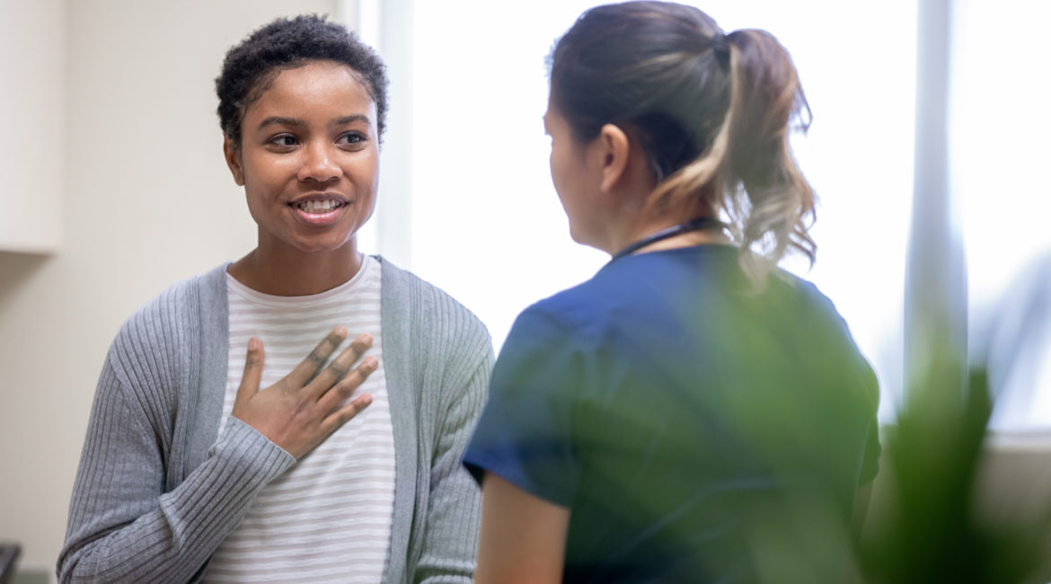 Nurse explaining good news to female patient